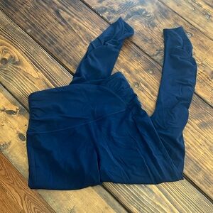 Lululemon navy leggings with ruched waist and lower leg on side.  Size 8.
